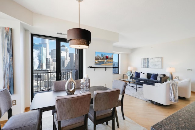 500 Grant St Unit 1302, Minneapolis, MN 55404 - dining space with visible vents and light wood finished floors