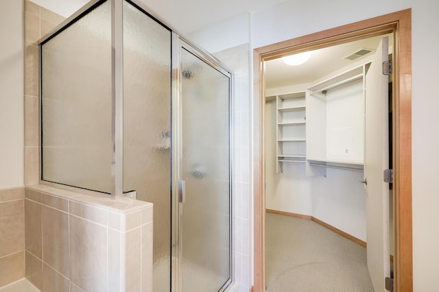 500 Grant St Unit 1302, Minneapolis, MN 55404 - bathroom featuring a walk in closet, a stall shower, and visible vents