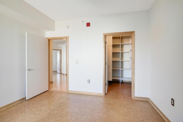 500 Grant St Unit 1302, Minneapolis, MN 55404 - unfurnished bedroom with baseboards and a spacious closet