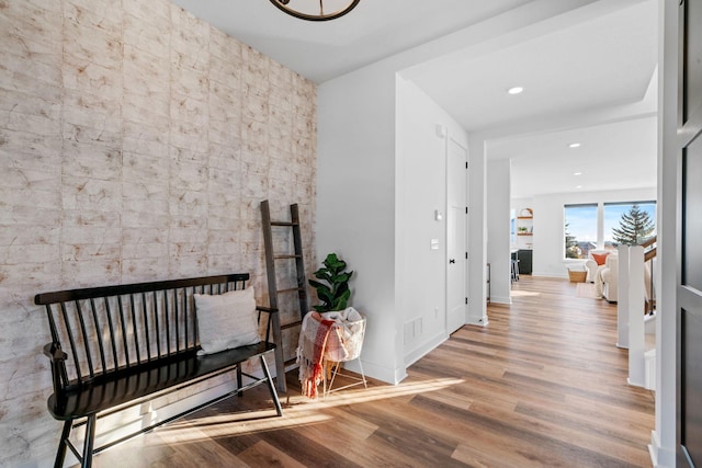 hall with recessed lighting, visible vents, baseboards, and wood finished floors