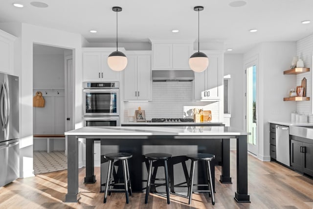 kitchen with white cabinets, stainless steel appliances, open shelves, and light countertops