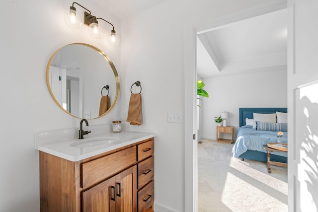 bathroom featuring ensuite bathroom, vanity, and baseboards