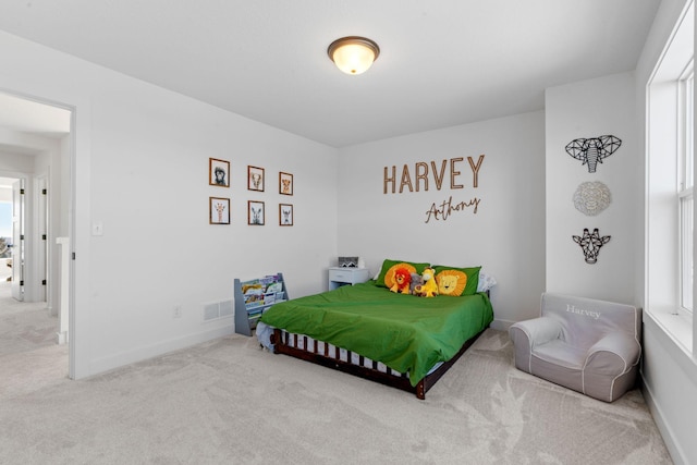 carpeted bedroom with visible vents, baseboards, and multiple windows