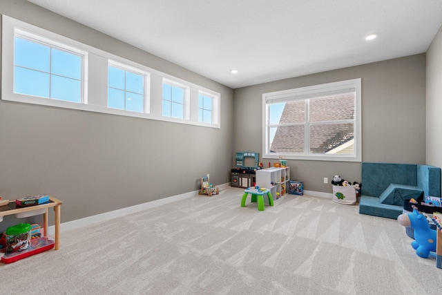 rec room with recessed lighting, light colored carpet, and baseboards