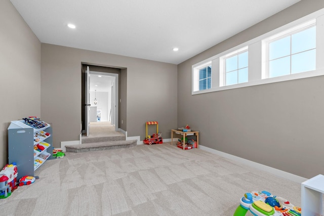 game room featuring recessed lighting, light colored carpet, and baseboards