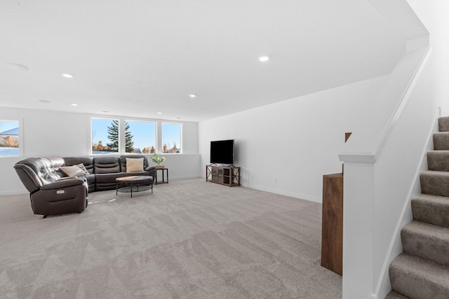 living room featuring recessed lighting, light carpet, baseboards, and stairs