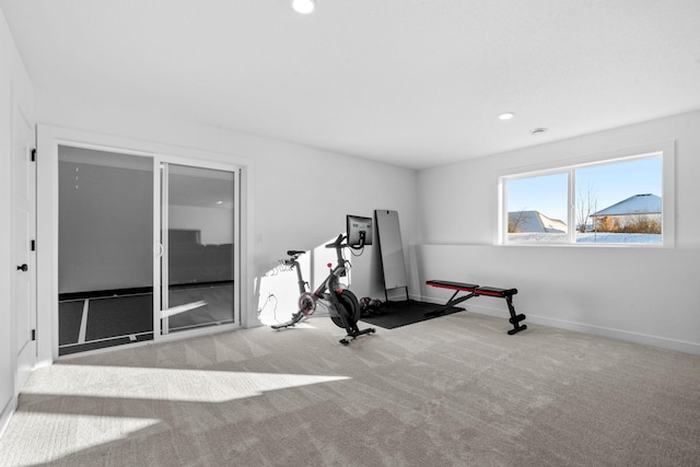 exercise room featuring light carpet, baseboards, and recessed lighting