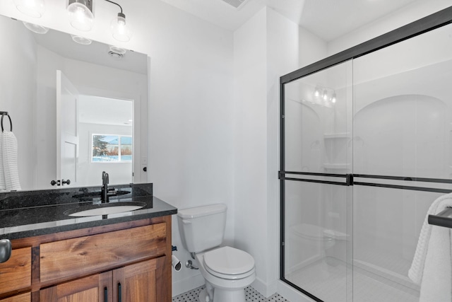 full bathroom with toilet, a stall shower, and vanity