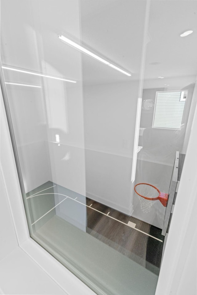 full bath featuring a shower and wood finished floors