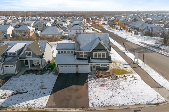 snowy aerial view with a residential view