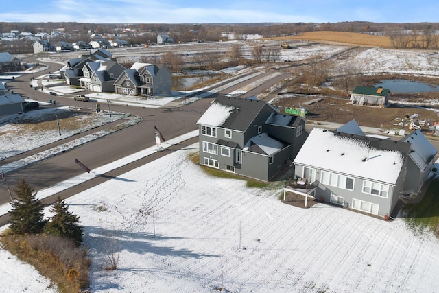 snowy aerial view with a residential view