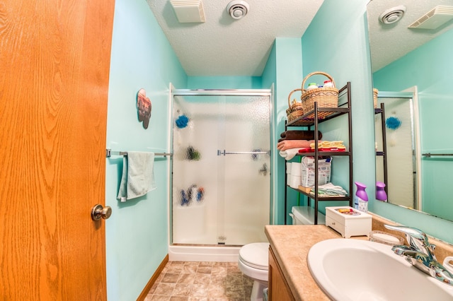 bathroom with visible vents, toilet, a shower stall, and a textured ceiling