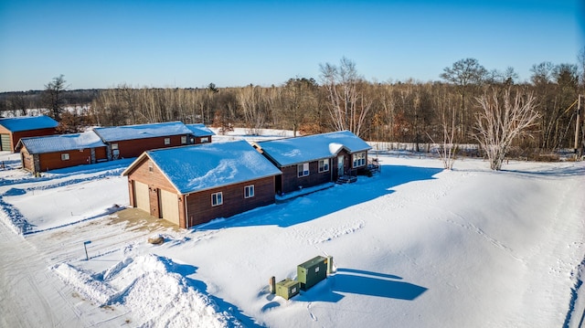 snowy aerial view with a forest view