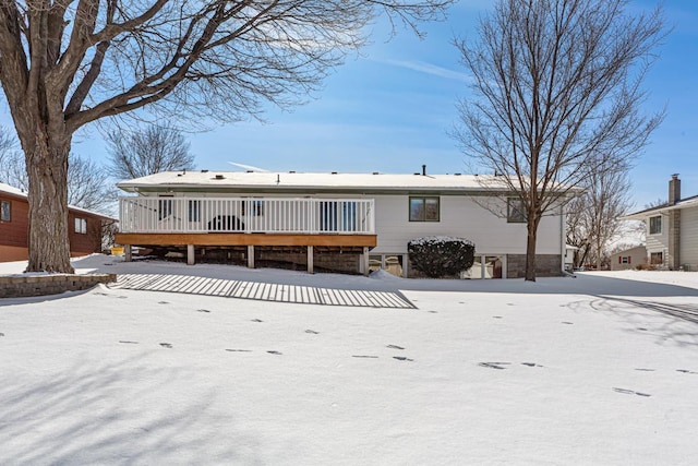 view of snow covered rear of property