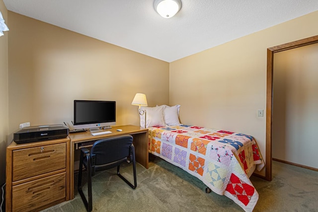 bedroom with a textured ceiling, dark carpet, and baseboards