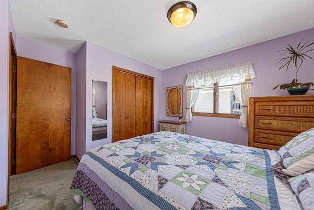 bedroom with light carpet, a closet, and a textured ceiling