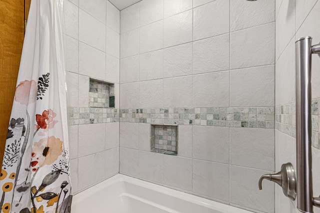 bathroom with shower / bath combo with shower curtain