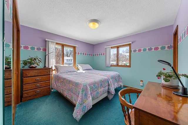 carpeted bedroom featuring a textured ceiling and multiple windows