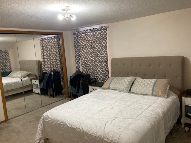 carpeted bedroom with a closet and a textured ceiling