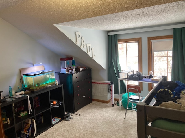 bedroom featuring light carpet and a textured ceiling
