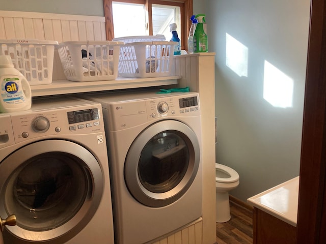 laundry room with dark wood-type flooring, a sink, and washer and clothes dryer