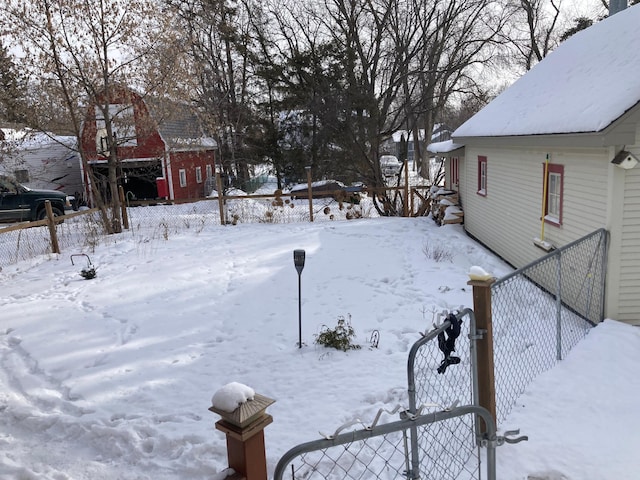 yard covered in snow featuring fence