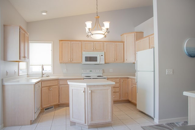 kitchen with white appliances, light countertops, hanging light fixtures, and light brown cabinetry