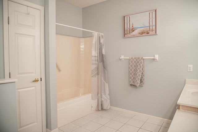 bathroom featuring shower / bath combo, tile patterned flooring, vanity, and baseboards