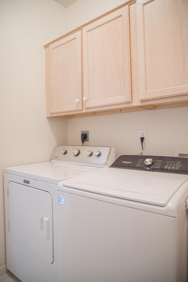 laundry room with cabinet space and washer and clothes dryer