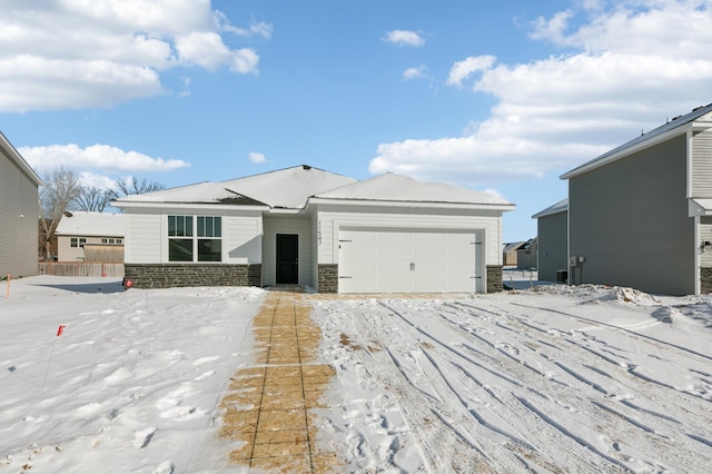 view of front facade with an attached garage and stone siding