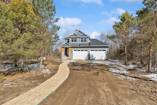 view of front of house featuring stone siding and driveway