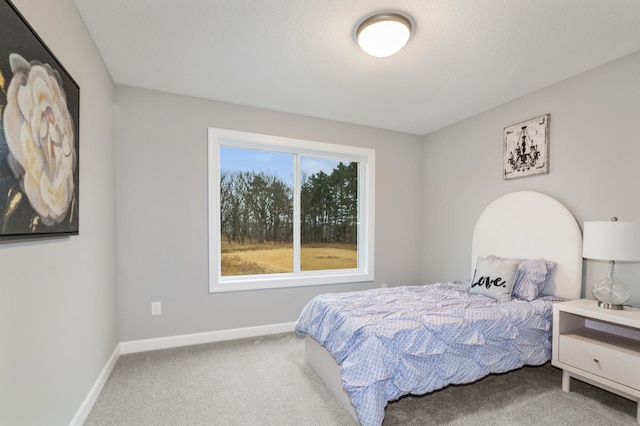 carpeted bedroom featuring baseboards