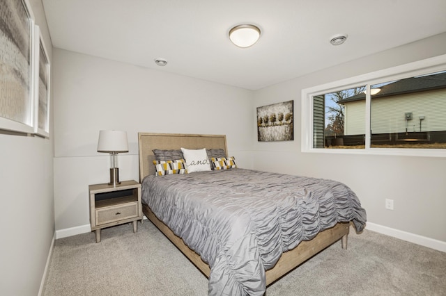 bedroom with carpet floors and baseboards