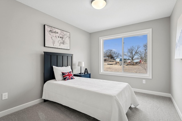 carpeted bedroom featuring baseboards