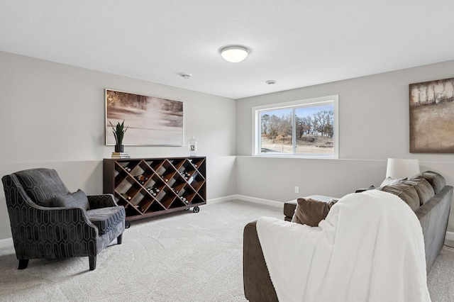 carpeted living room with baseboards