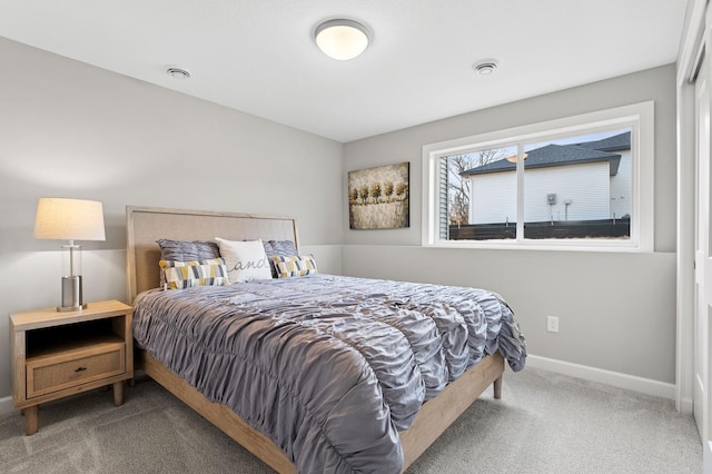 carpeted bedroom featuring visible vents and baseboards