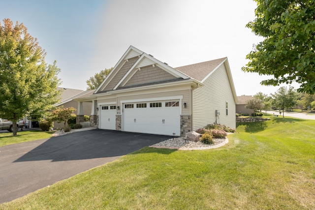 view of front facade with stone siding, aphalt driveway, a front lawn, and an attached garage