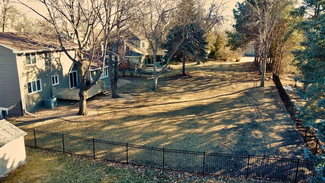 view of yard featuring cooling unit, fence, and a wooden deck