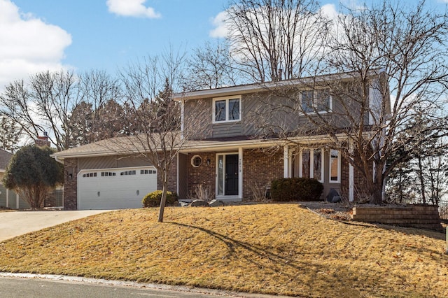 traditional-style house with a garage, driveway, and brick siding