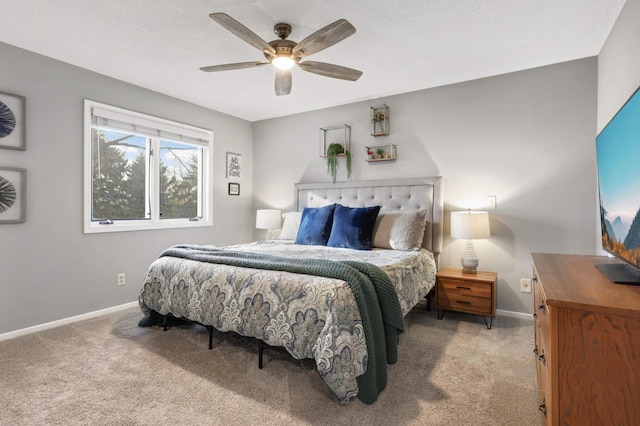 bedroom featuring ceiling fan, baseboards, and light colored carpet