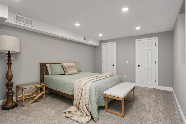 carpeted bedroom featuring baseboards, visible vents, and recessed lighting