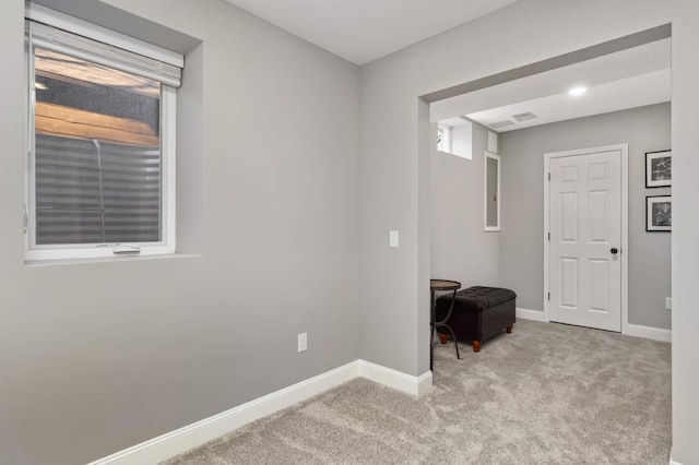 unfurnished room with carpet floors and baseboards