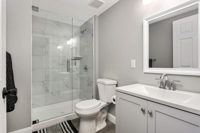 bathroom with visible vents, a shower stall, toilet, and vanity