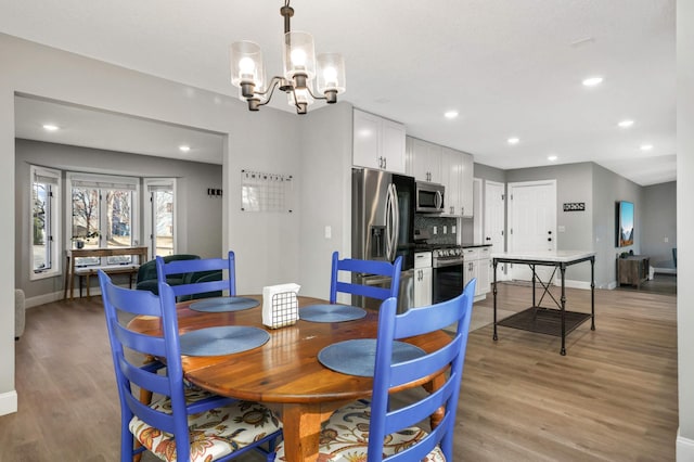 7879 Juneau Ln N, Maple Grove, MN 55311 - dining area featuring a chandelier, light wood-style flooring, baseboards, and recessed lighting