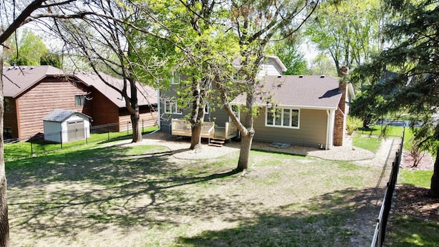 7879 Juneau Ln N, Maple Grove, MN 55311 - rear view of property with a deck, a fenced backyard, a chimney, a shed, and an outdoor structure