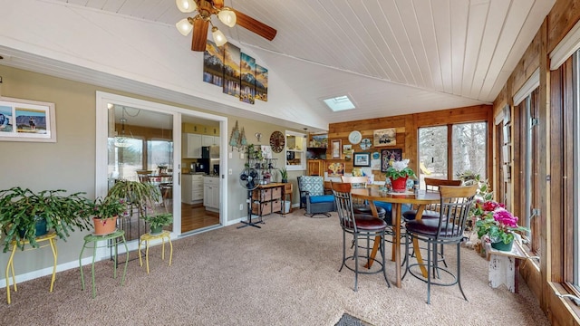 sunroom / solarium featuring lofted ceiling, wooden ceiling, and a wealth of natural light