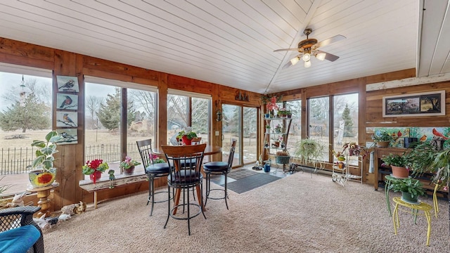 sunroom / solarium featuring wooden ceiling, vaulted ceiling, and a ceiling fan