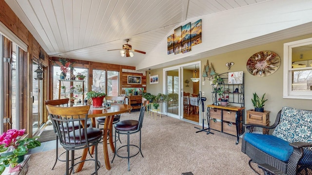 sunroom featuring lofted ceiling, wood ceiling, and a ceiling fan