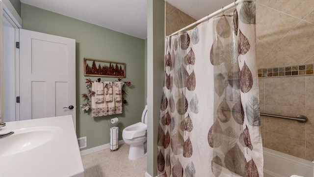 bathroom featuring baseboards, visible vents, toilet, tile patterned flooring, and a sink