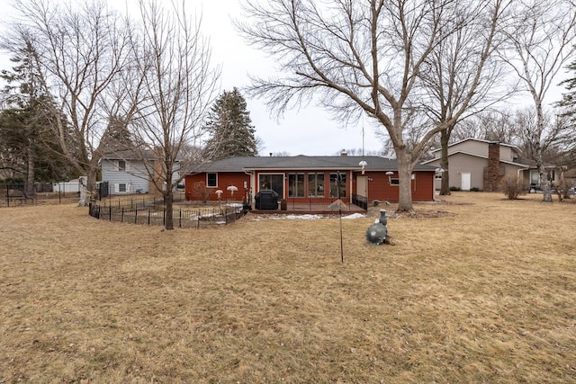 back of property featuring a yard and fence